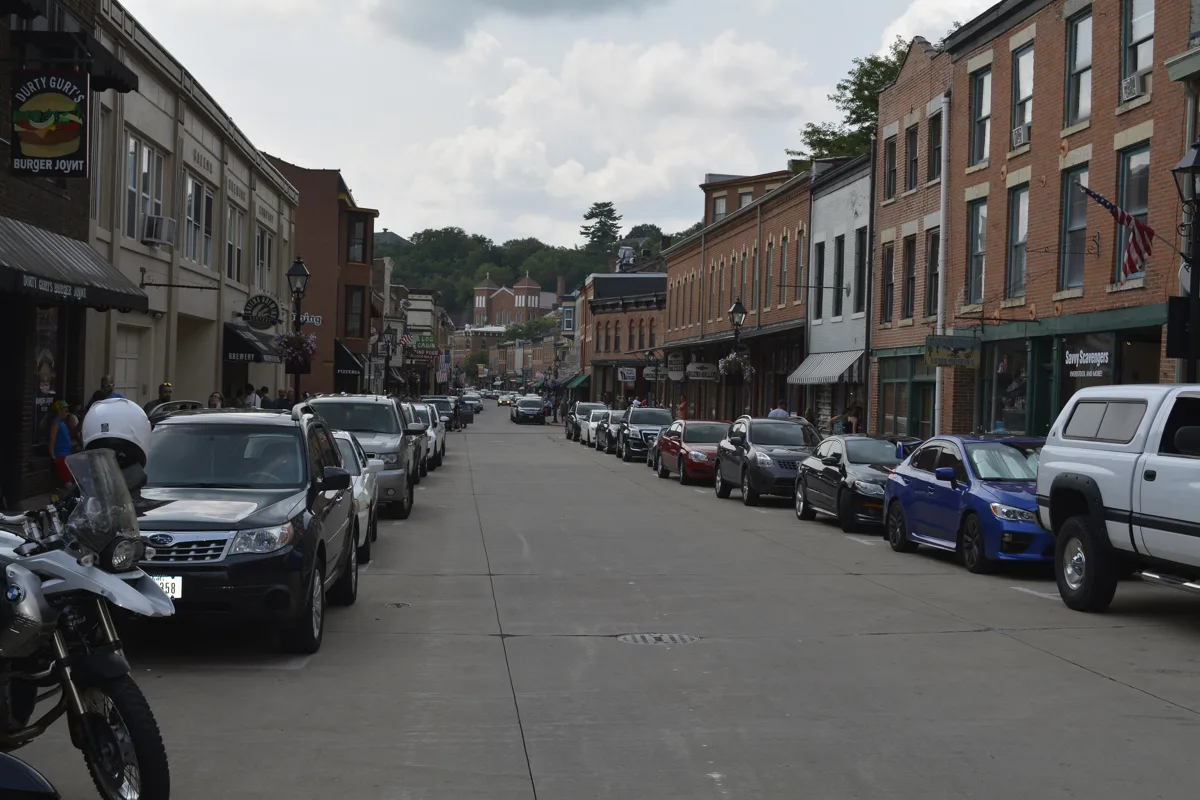 Main Street in Galena looking south, brick storefronts and parked cars under a blue sky