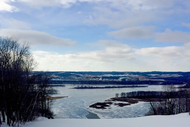 The Mississippi River in winter from the bluffs at Chestnut Mountain, with snow and bare trees