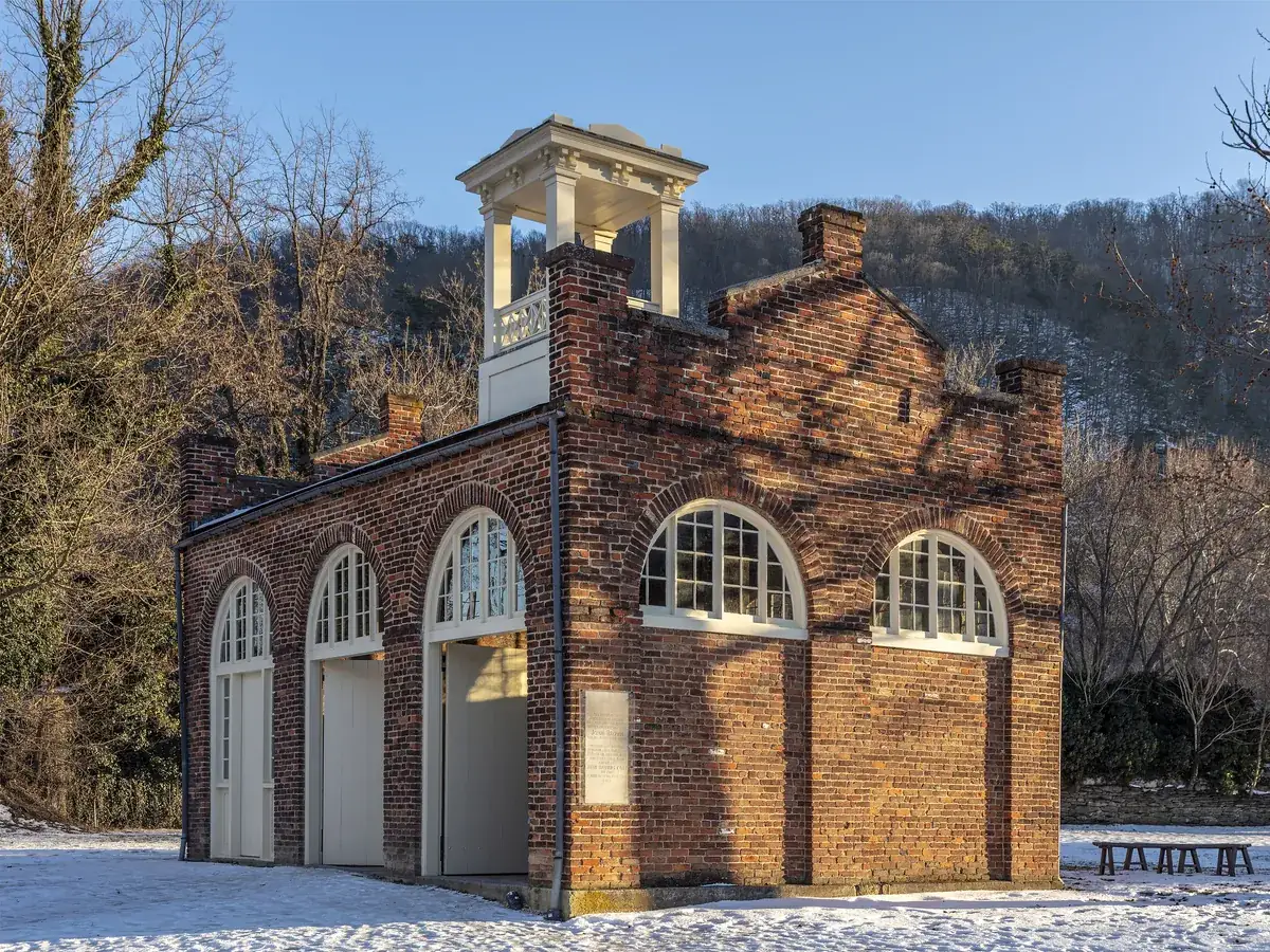 John Brown’s Fort, a small brick engine house with arched doors and a cupola, in Lower Town Harpers Ferry