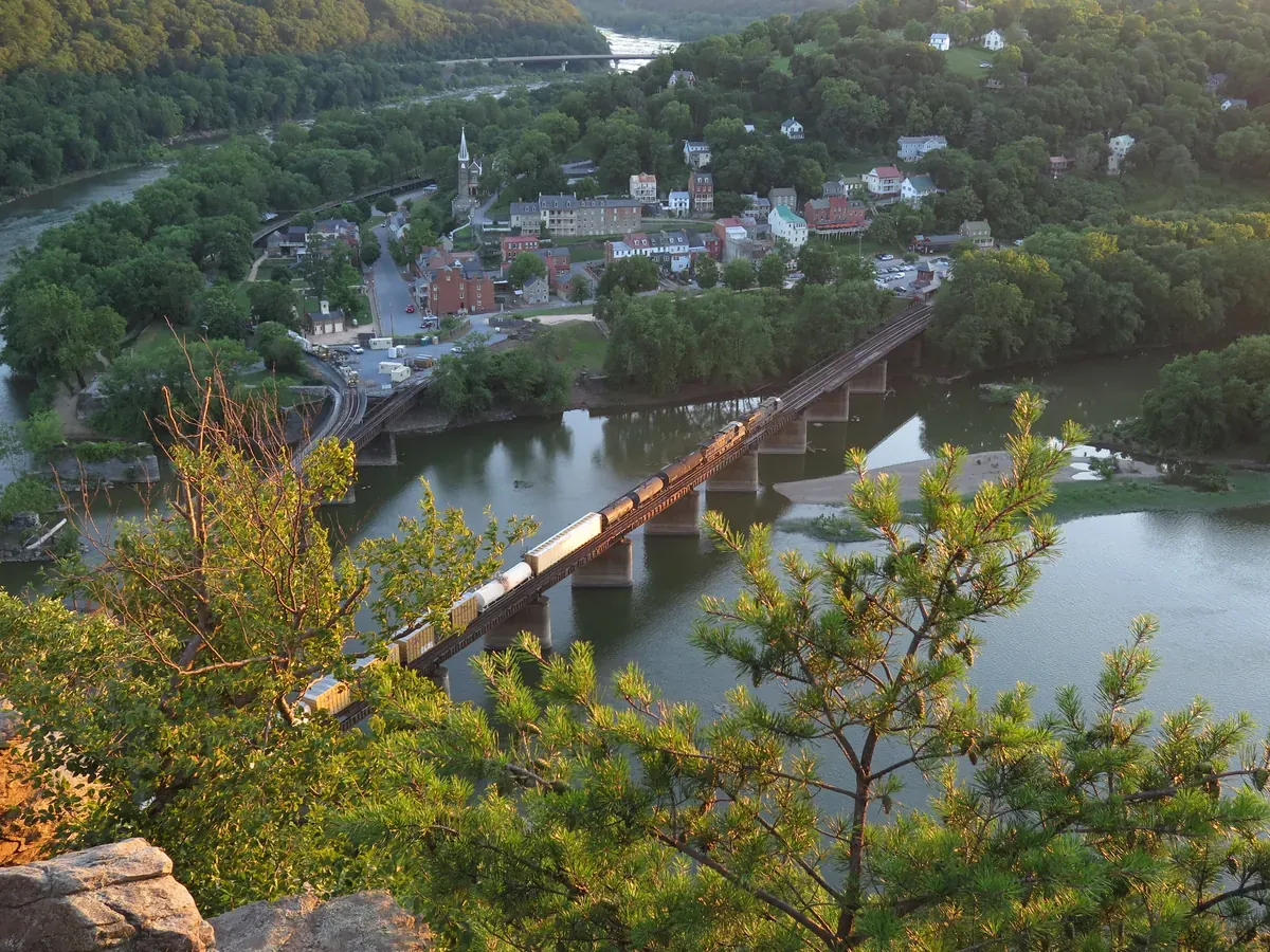 The view from the Maryland Heights overlook down to Harpers Ferry, the rivers and the bridges in summer green