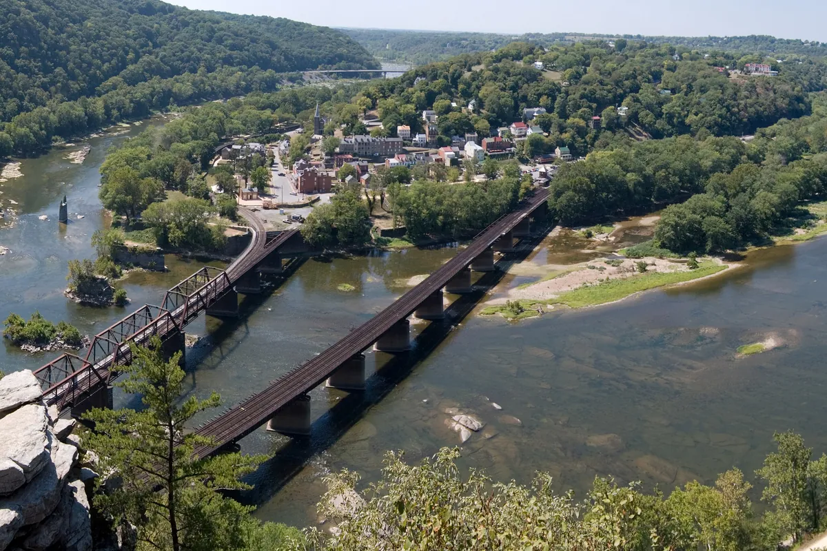 Harpers Ferry seen from Maryland Heights, the town on its point between the Shenandoah and Potomac rivers with railroad bridges below