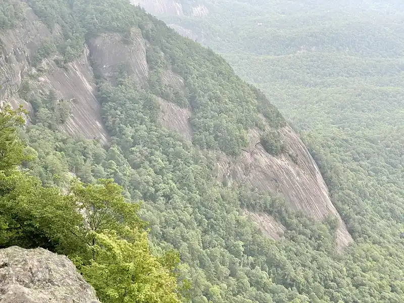 Sheer granite cliffs of Whiteside Mountain above forested valleys