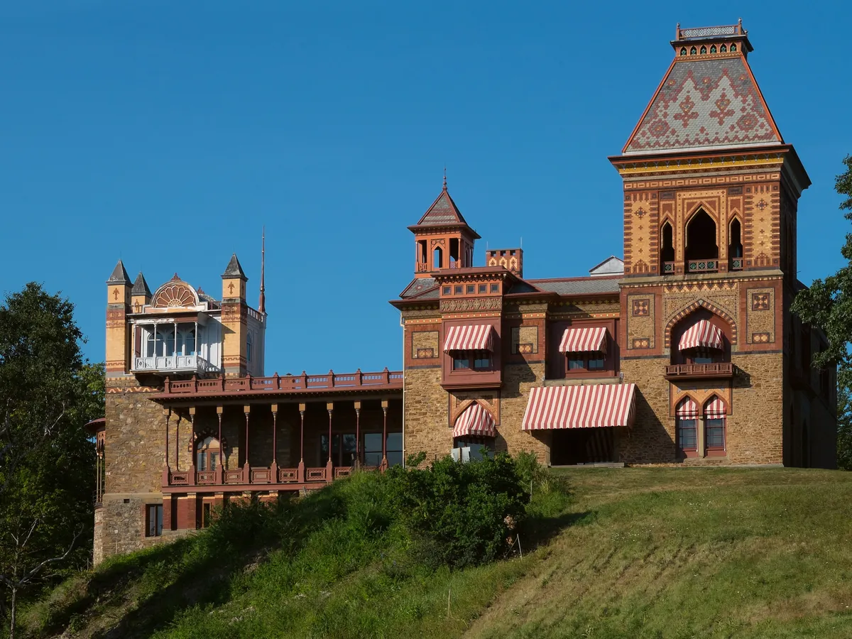 Olana, Frederic Church’s hilltop villa of patterned brick with a tall square tower, above a green lawn