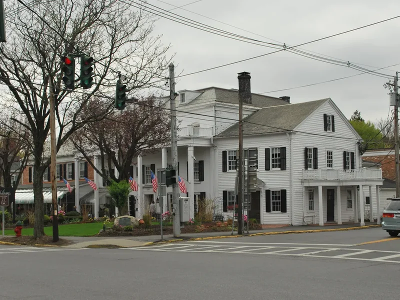 The white clapboard Beekman Arms inn at the main crossroads of Rhinebeck, with bare trees in front