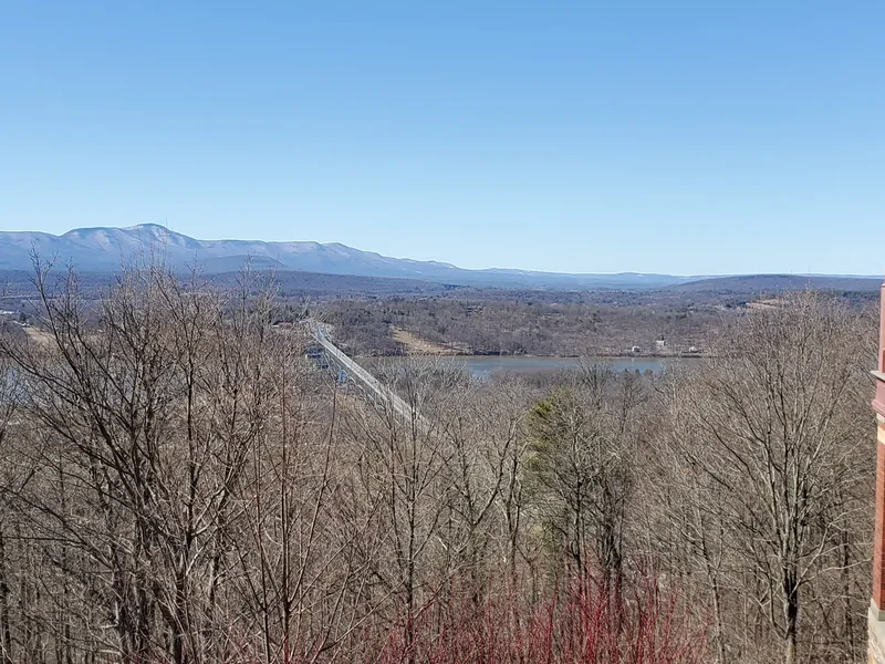 The Rip Van Winkle Bridge and the Catskill Mountains seen through bare trees from the grounds of Olana
