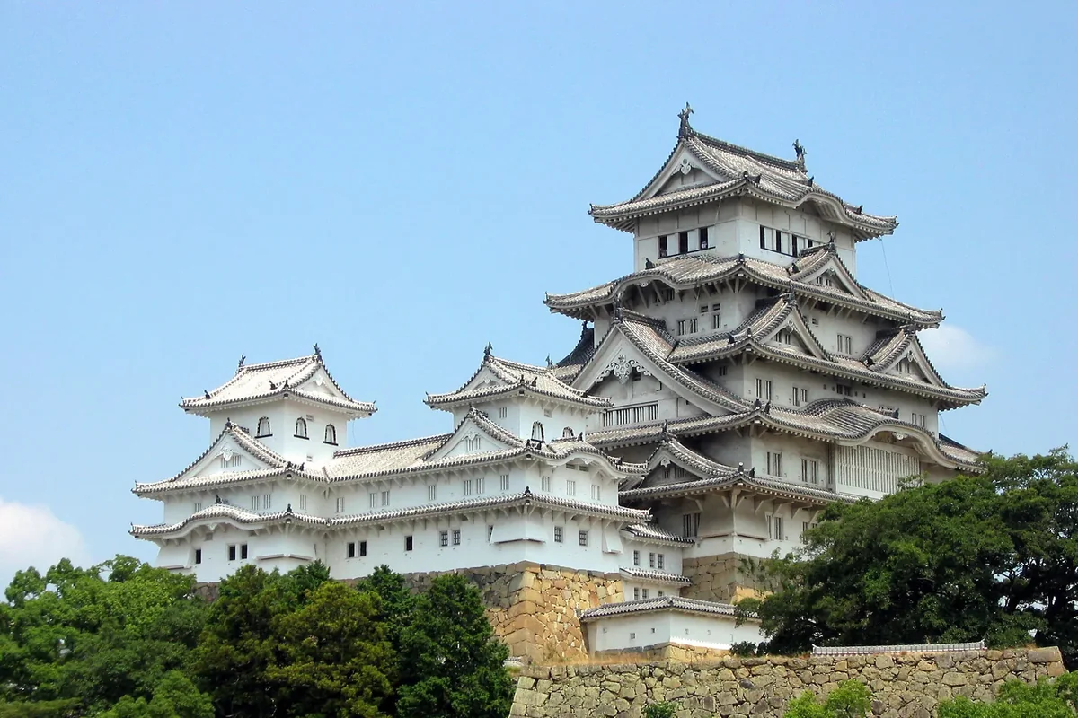 Himeji Castle’s white keep above its stone walls and trees