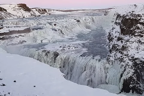 Gullfoss waterfall pouring into a snowy canyon in winter