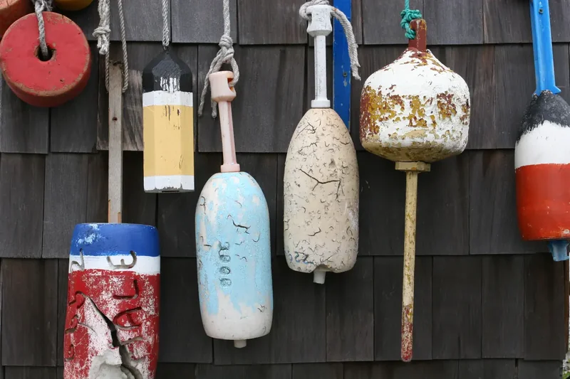 Colorful lobster buoys hanging on the weathered shingles of a shack in Kennebunkport