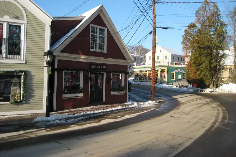 Ocean Avenue in Kennebunkport curving past clapboard houses, with snow along the edges