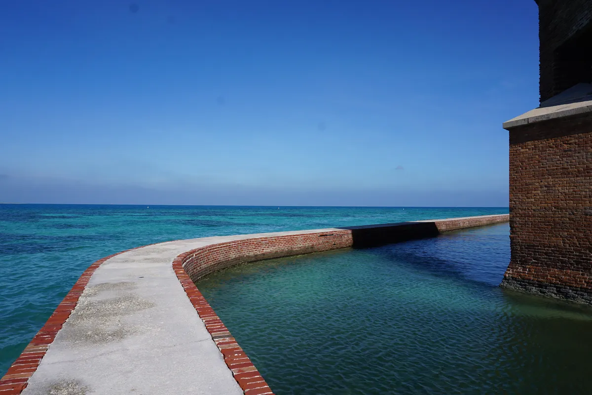 The red-brick wall of Fort Jefferson rising from its moat in Dry Tortugas National Park