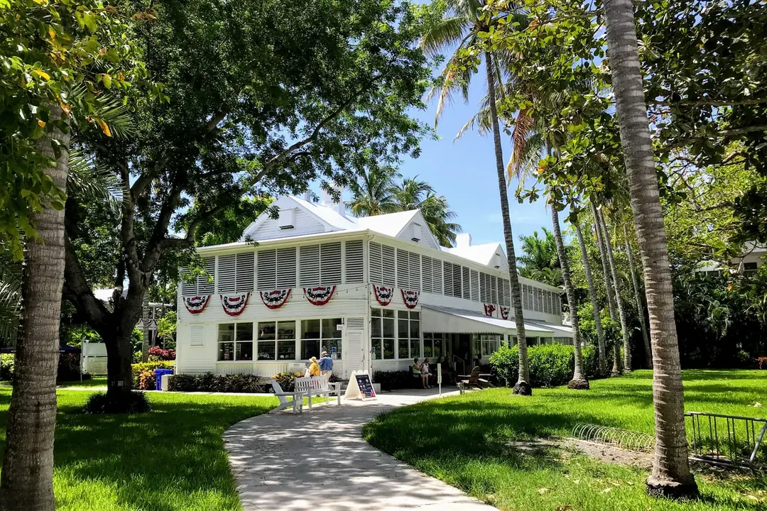 The white Truman Little White House with its porch and shutters among palms in Key West