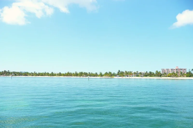 Smathers Beach in Key West with palms, sand and shallow water