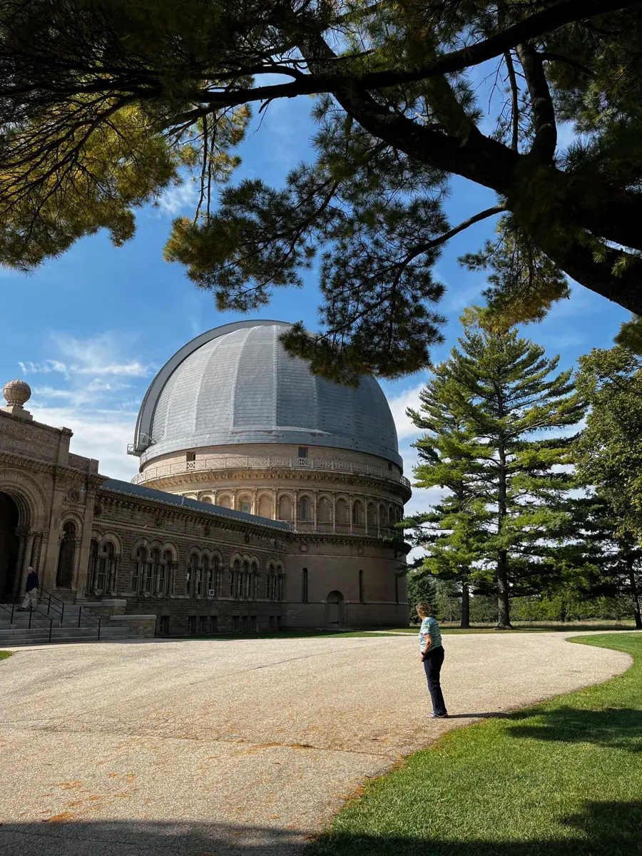The domes of Yerkes Observatory above a lawn and trees in Williams Bay
