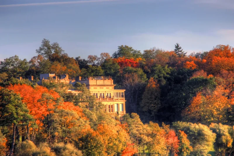 A large lakeside house among autumn trees on Geneva Lake