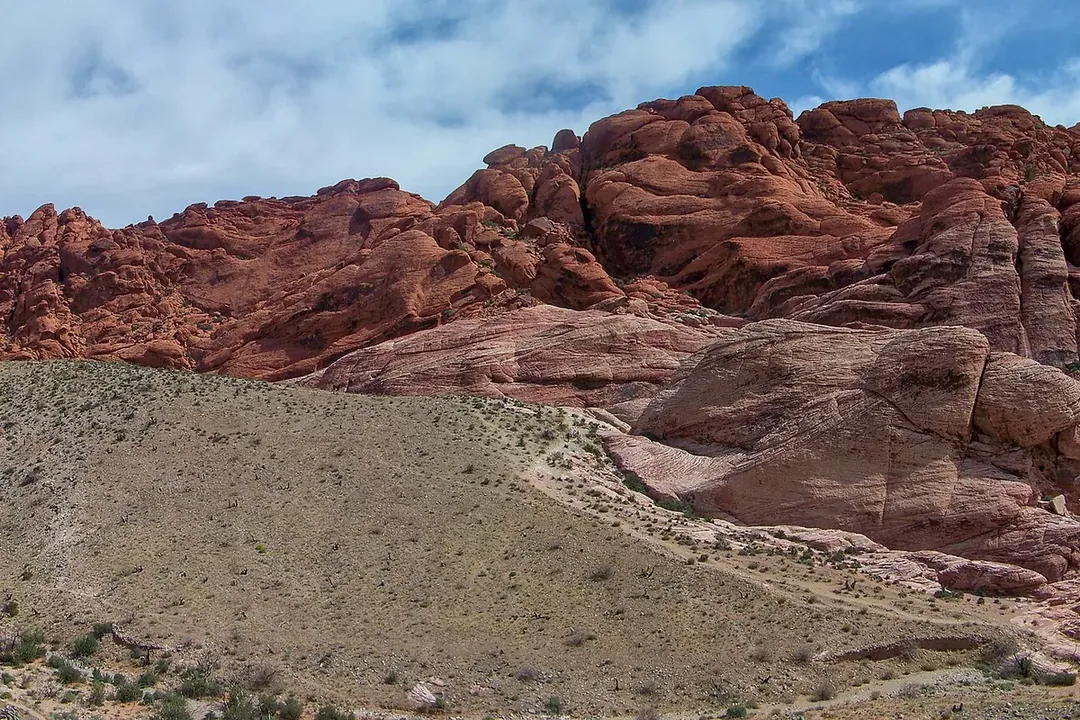 The red and cream Calico Hills of Red Rock Canyon rising above desert scrub under a blue sky