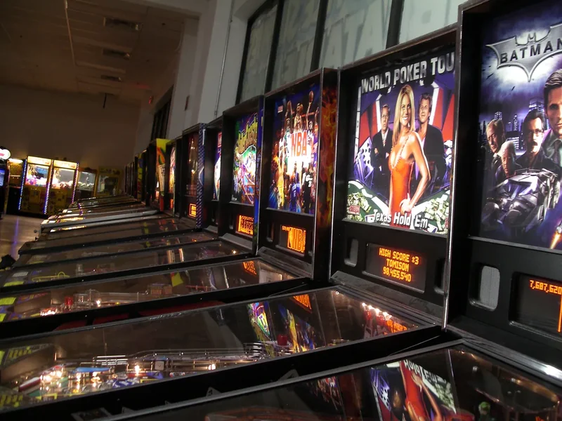 A long row of lit pinball machines inside the Pinball Hall of Fame
