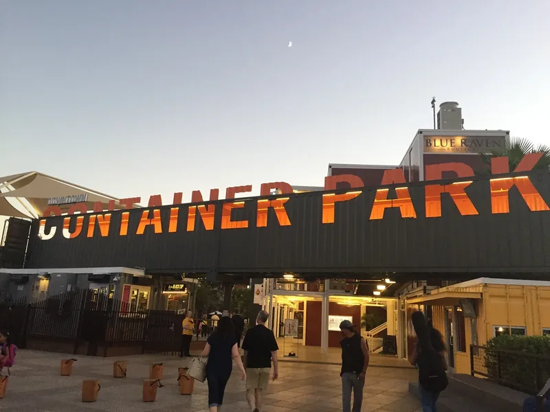 The lit Container Park sign over the entrance of the Downtown Container Park at dusk