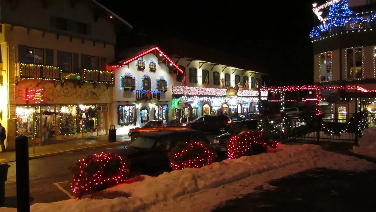 Leavenworth's Bavarian village lit up at night with Christmas lights and snow
