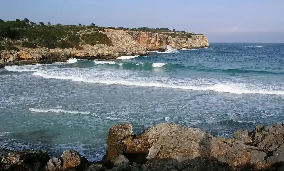 Turquoise water and limestone cliffs at Cala Varques, Mallorca