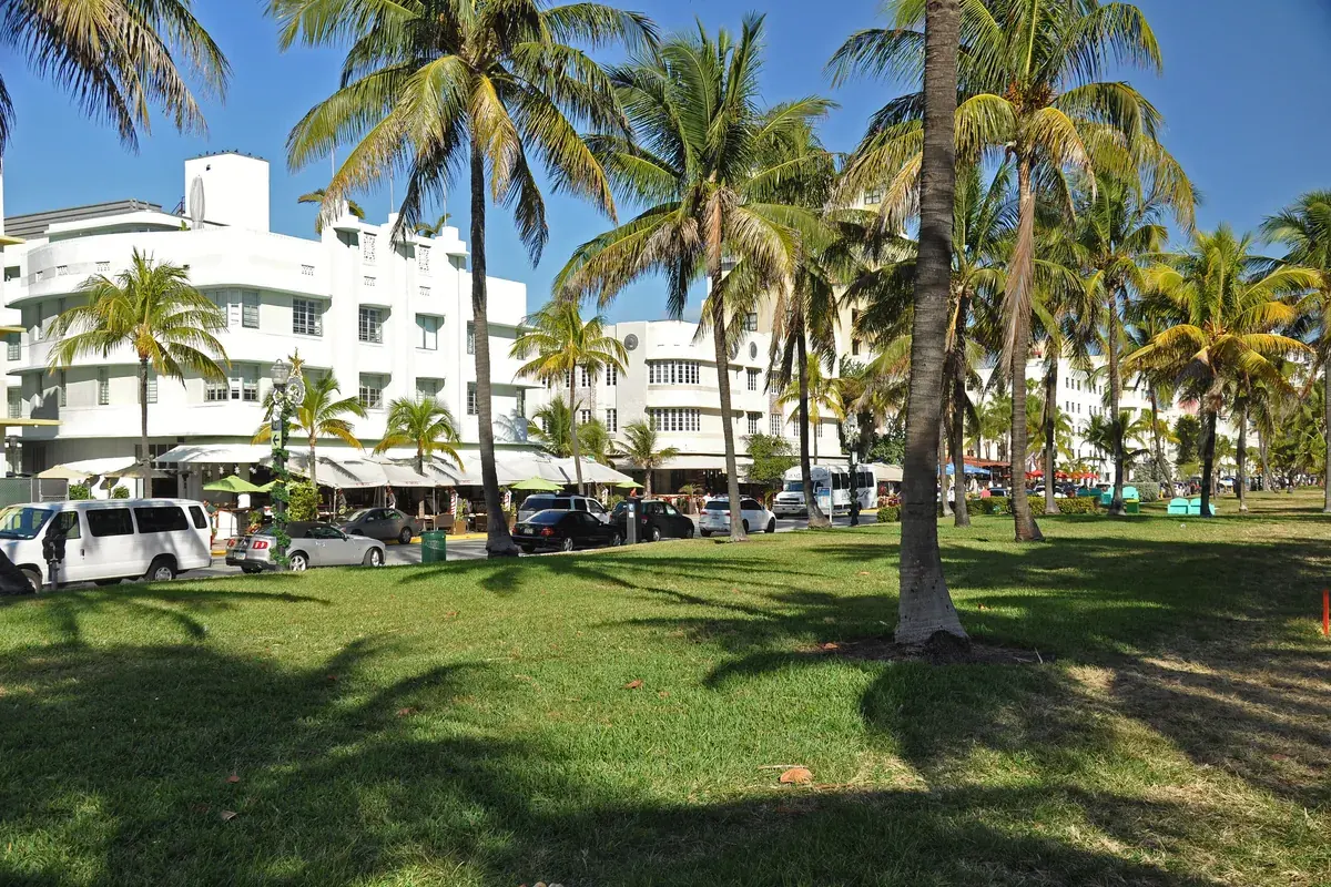 Lummus Park’s lawns and palms with Art Deco hotels behind, Miami Beach