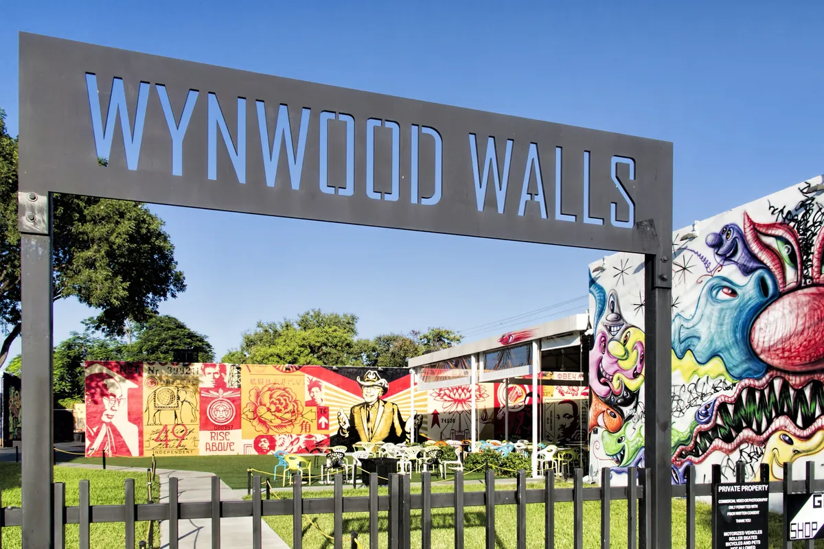 The entrance sign and colorful murals of the Wynwood Walls in Miami