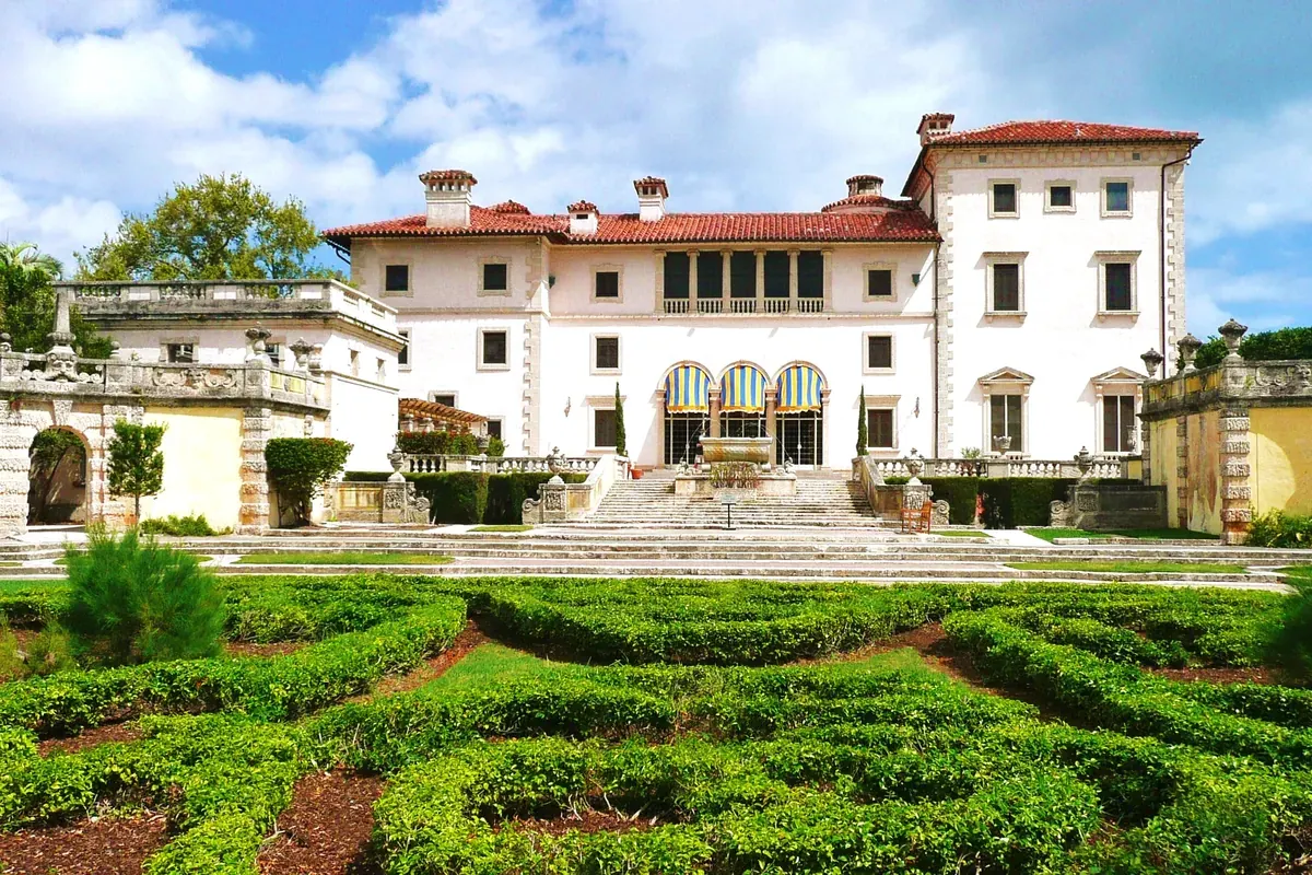 The villa at Vizcaya Museum and Gardens behind its formal hedge garden
