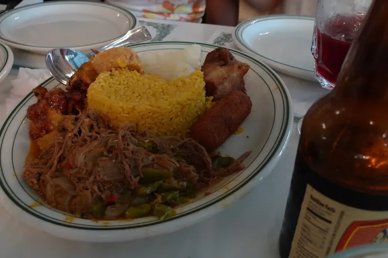 A plate of ropa vieja with rice and plantains at Versailles in Little Havana