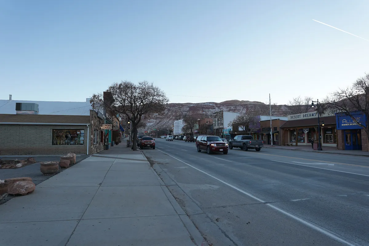 Main Street in Moab, Utah, with red cliffs behind the town