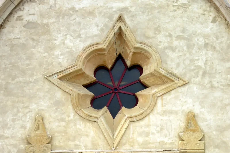 The stone front of the Carmel Mission Basilica with its bell tower