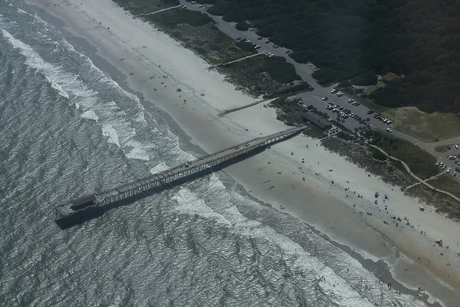 Aerial view of a fishing pier stretching into the Atlantic at a South Carolina state park beach