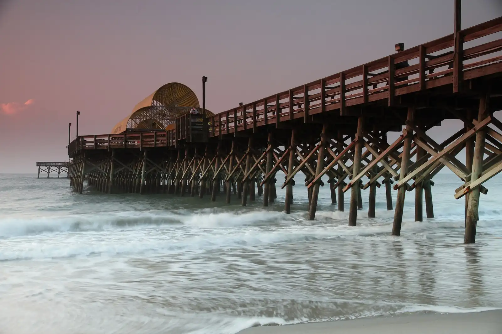 The Apache Pier at sunset over the Myrtle Beach shoreline