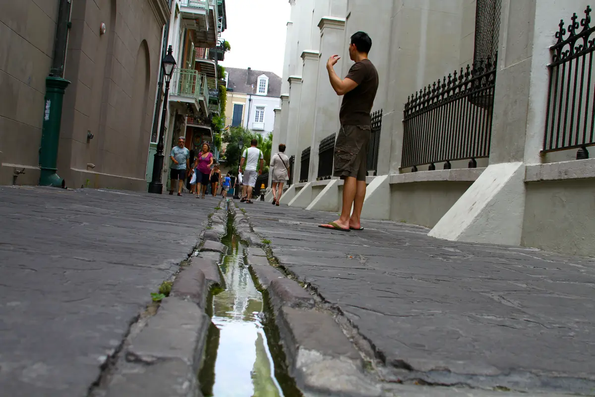 French Quarter street scene showing uneven sidewalks