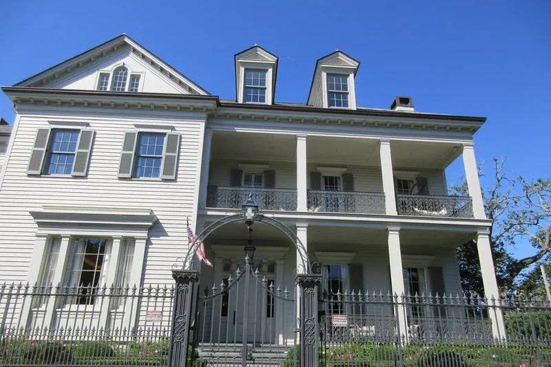 A Garden District house with a gallery and iron fence in New Orleans
