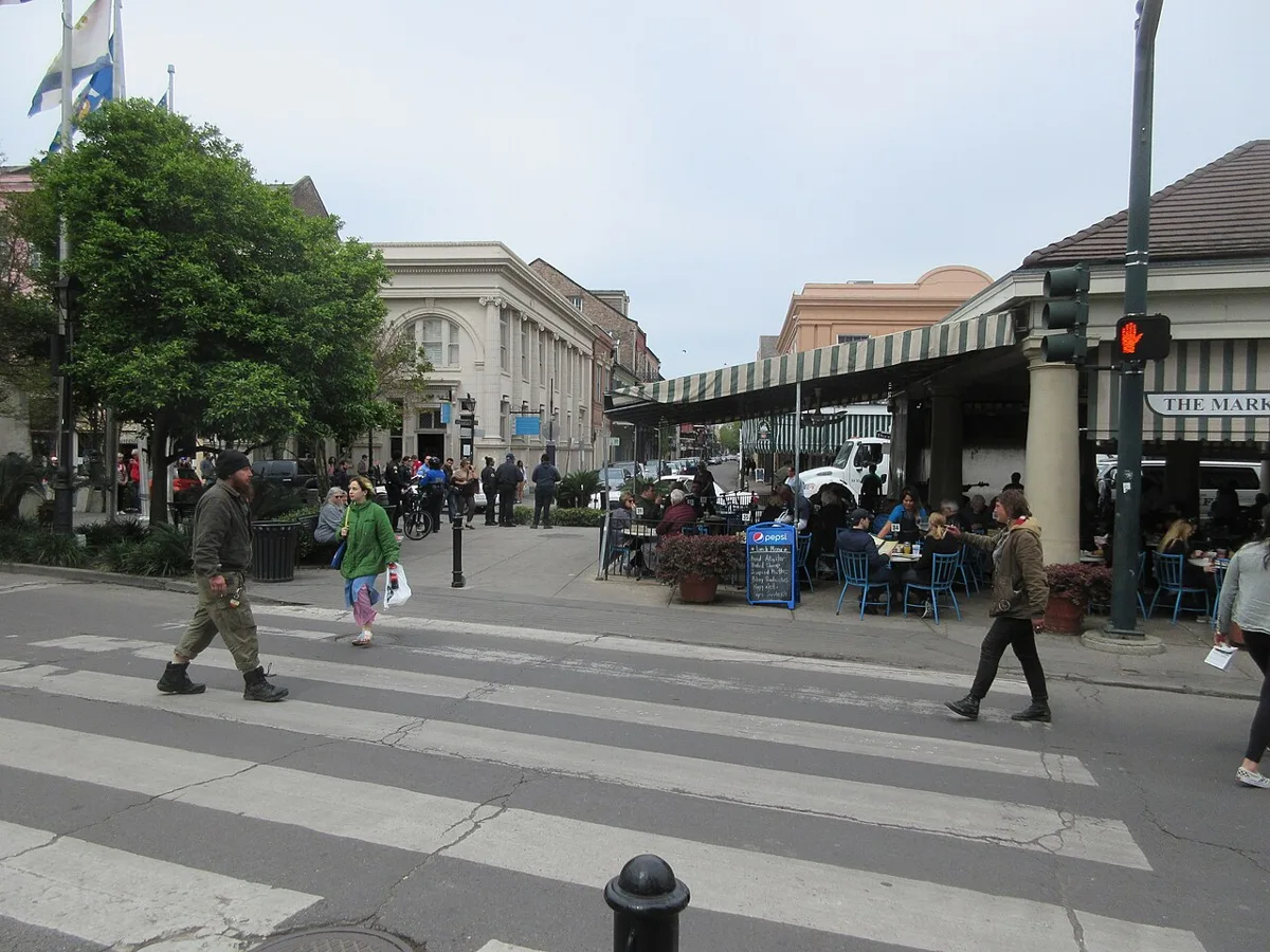 People crossing Decatur Street at the colonnade of the French Market in New Orleans