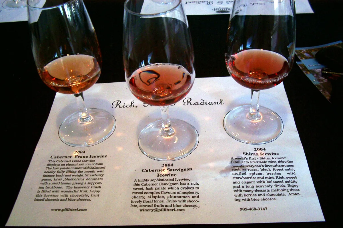 A small glass of golden icewine on a tasting table