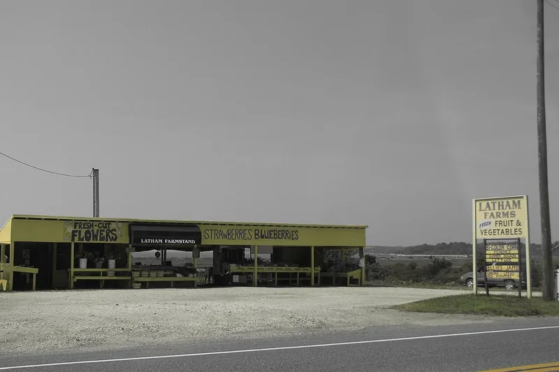 A long open-sided farm stand with flowers and fruit beside a North Fork road, photographed in 2006