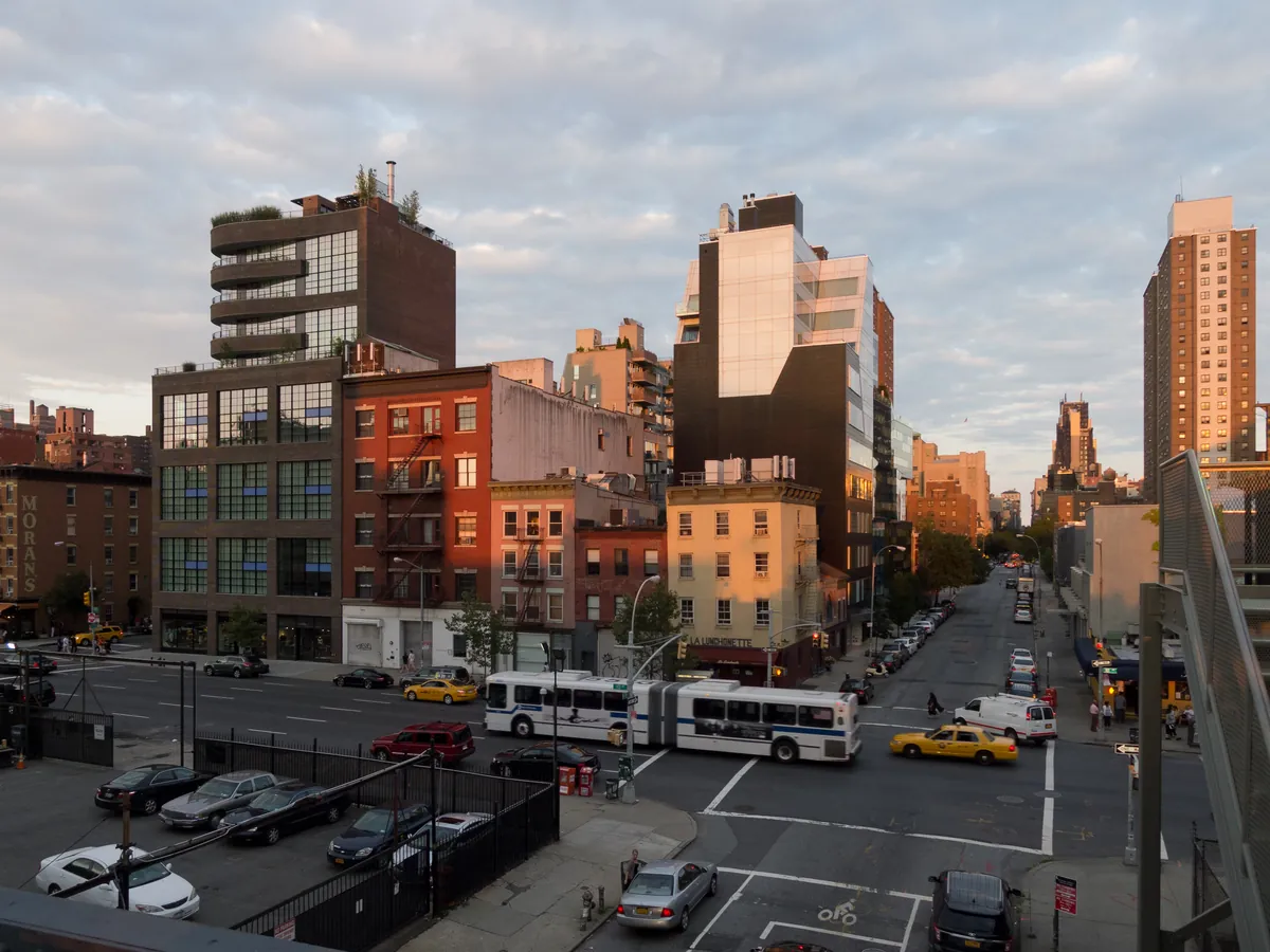 The High Line elevated park with planted beds and a walkway between buildings, looking east over West Chelsea