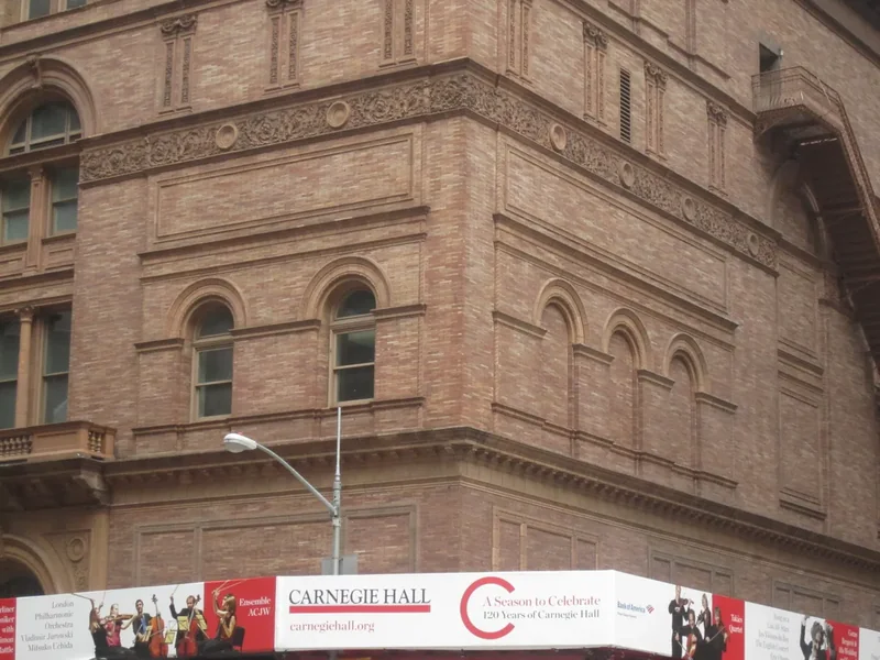The brick and terracotta facade of Carnegie Hall on Seventh Avenue at 57th Street