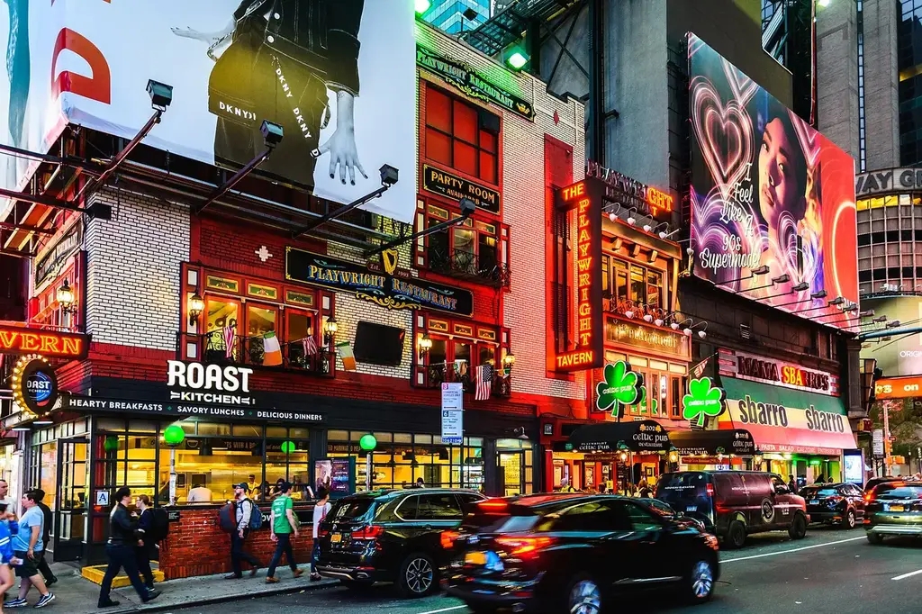 Times Square glowing at dusk
