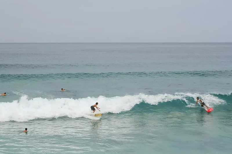 Surfers riding waves at Sunset Beach on the North Shore of Oahu