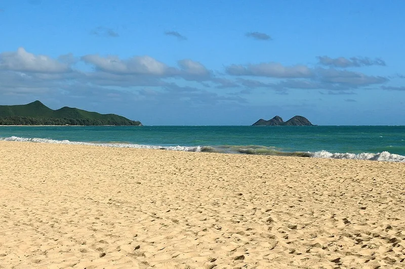 Waves breaking on Waimānalo Beach with the Mokulua islets on the horizon