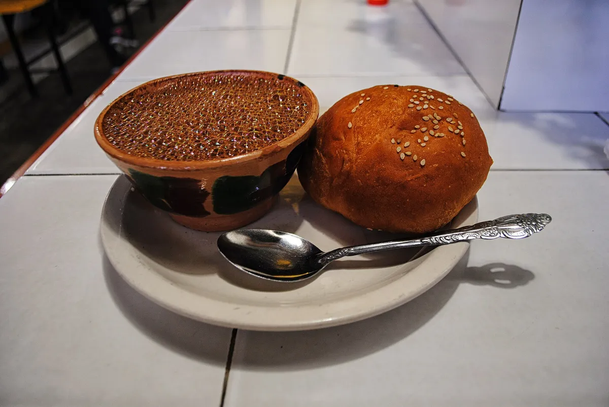 A cup of hot chocolate and pan de yema at the Mercado 20 de Noviembre in Oaxaca