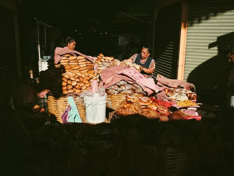 A bread stall stacked with loaves at the Mercado 20 de Noviembre