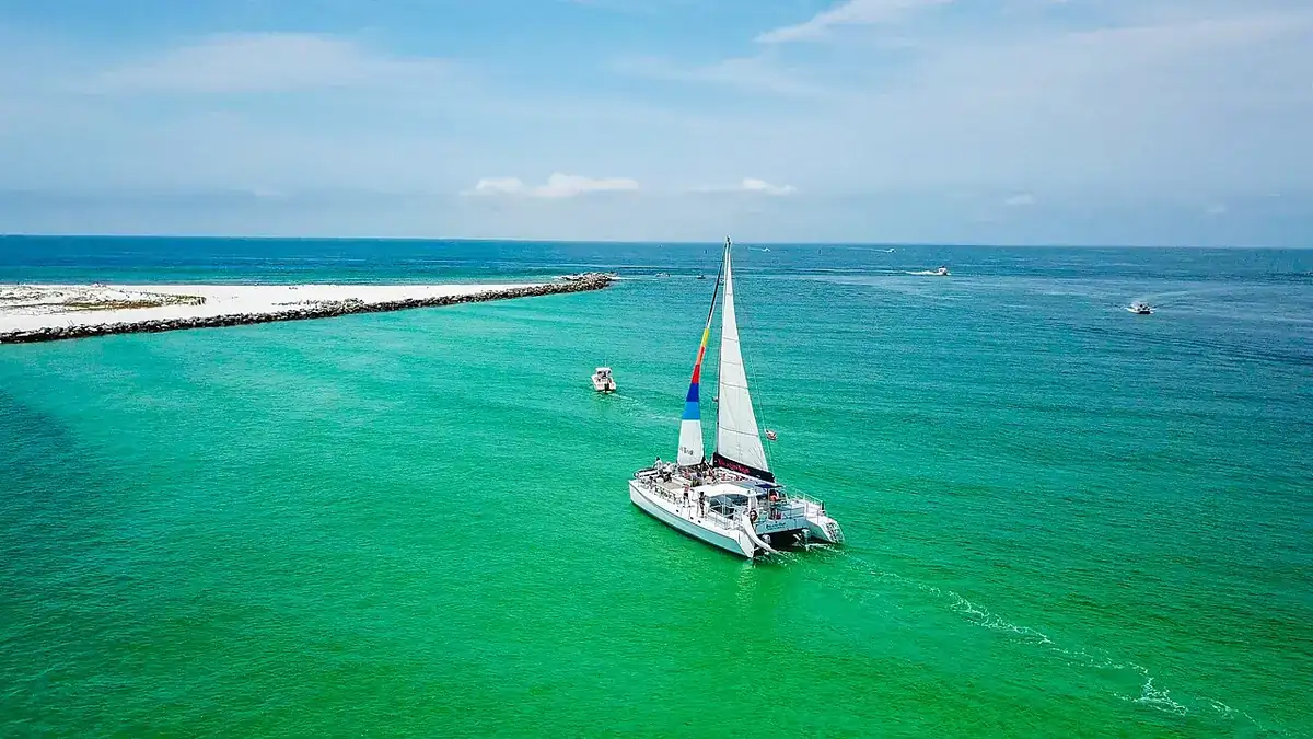 A sailing catamaran off Shell Island's undeveloped shoreline