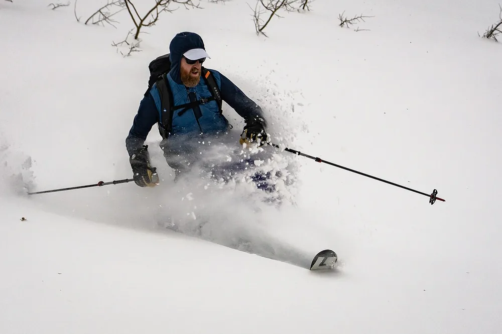 Skier carving through deep Utah powder