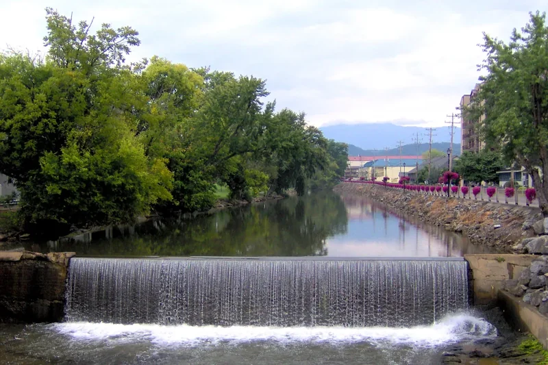 The old mill dam on the Little Pigeon River with trees along the banks
