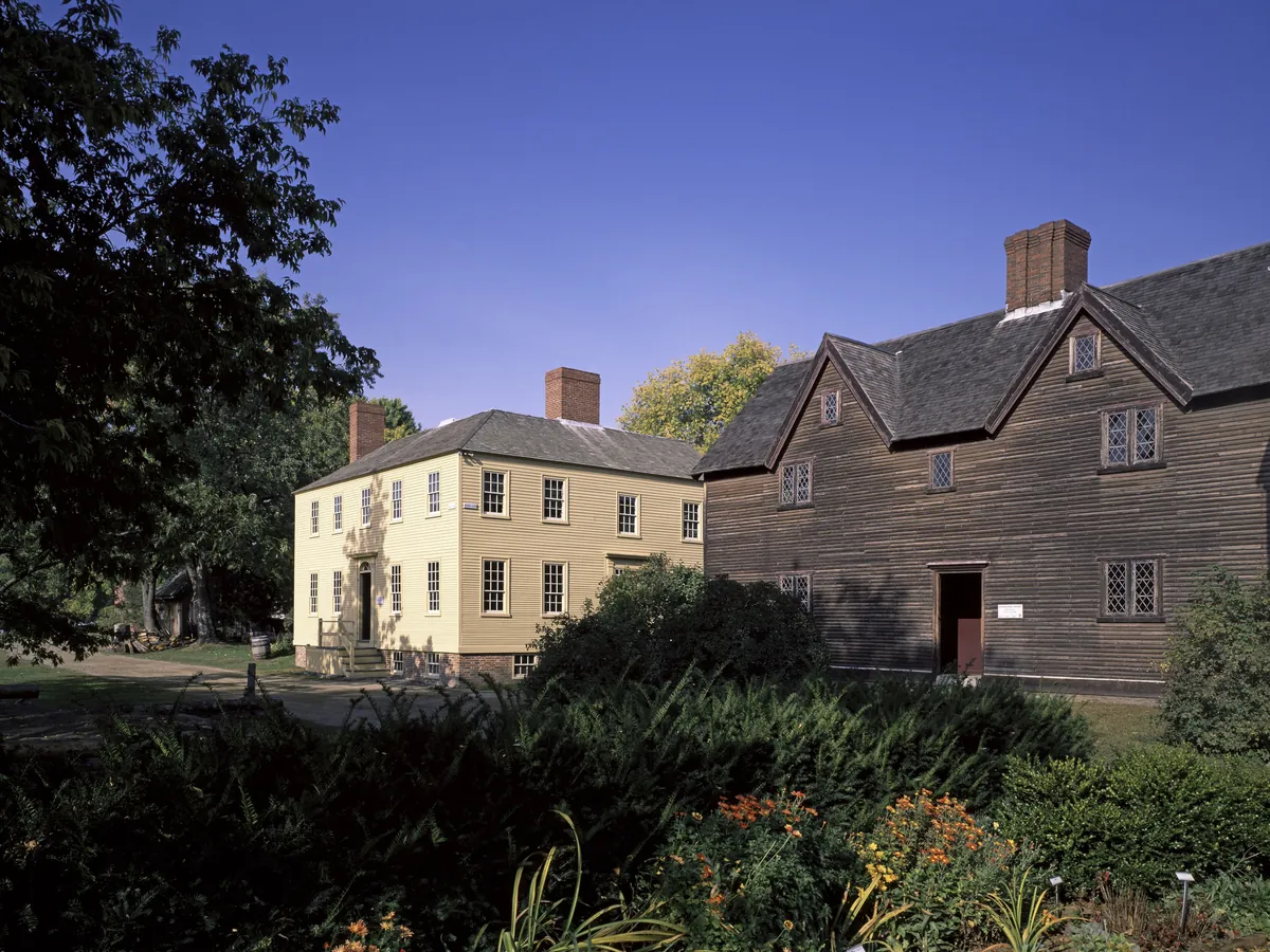 Old wooden and clapboard houses at Strawbery Banke with a garden in front