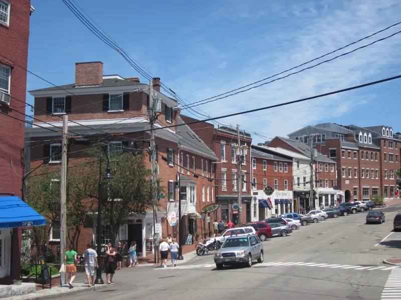 Bow Street in Portsmouth with brick buildings and shops on a sunny day