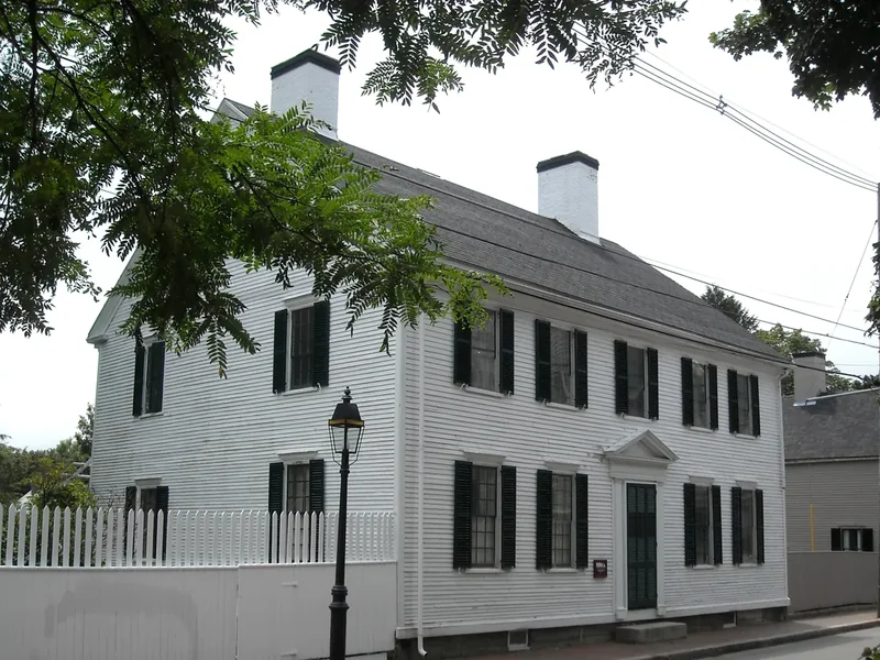 A white two-story colonial house at Strawbery Banke with black shutters