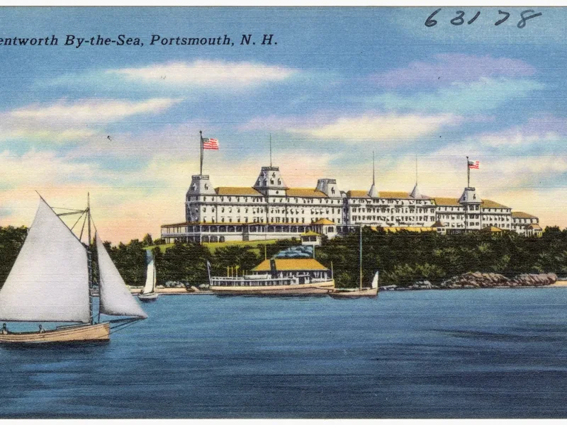 An old color postcard of the Wentworth by the Sea hotel with a sailboat in front